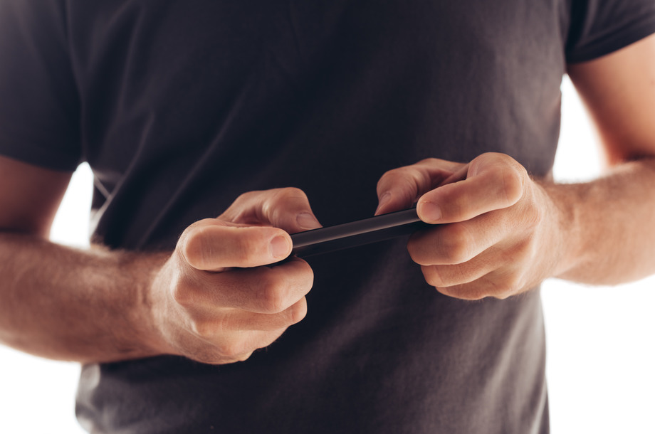 Man playing mobile video game on smartphone